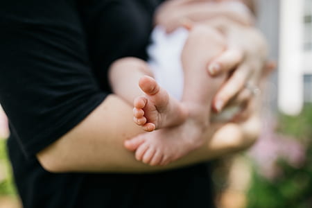 woman carrying baby thumbnail