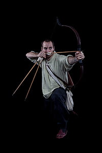 man focusing target using composite bow thumbnail