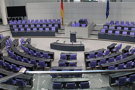 flags of Germany and Australia on poles of conference room thumbnail
