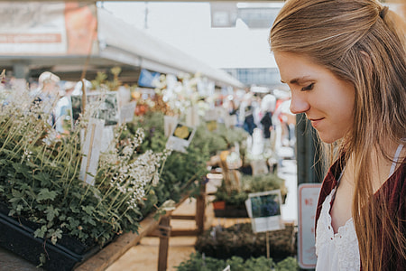 woman standing in front of flowers thumbnail
