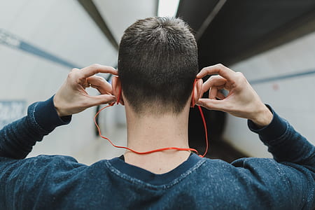 man wearing red wireless headphones thumbnail