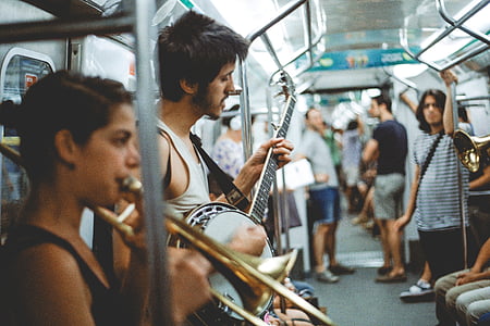 band performing inside train with other passengers thumbnail