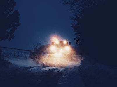brown lighted vehicle near tree during night time thumbnail