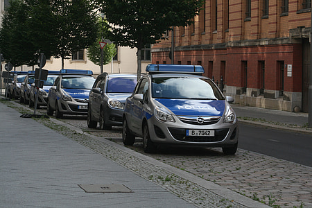 group of police cars parked near sidewalk thumbnail