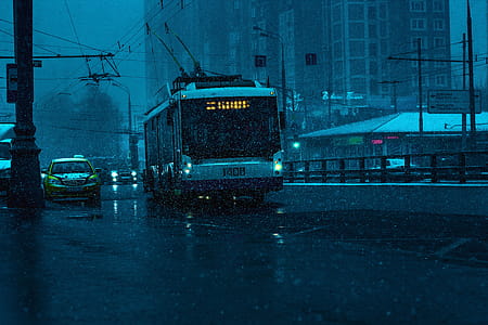 Bus and Gray Car on Road While Raining in City thumbnail