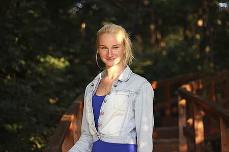 woman in blue top wearing denim jacket thumbnail