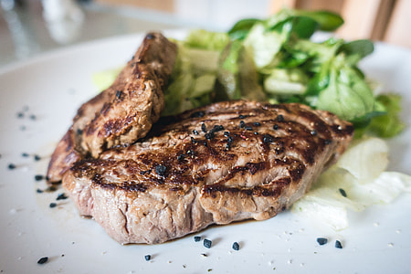 Beef steak with green salad close up thumbnail