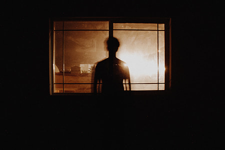 silhouette of man standing near window thumbnail
