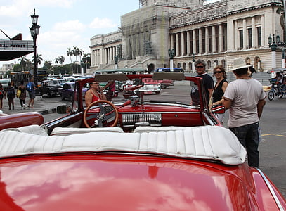 man standing beside convertible car at daytime thumbnail