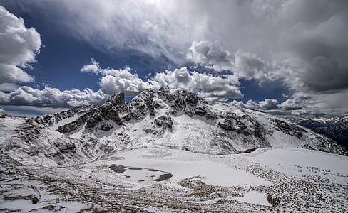glacier mountain below white and blue sky thumbnail