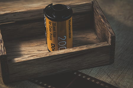 black and yellow KodaColor 35mm film on brown wooden rack thumbnail