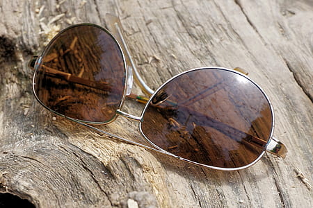 Silver Aviator Sunglasses on Top of Wooden Surface thumbnail