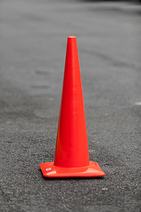 orange traffic cone on black asphalt thumbnail
