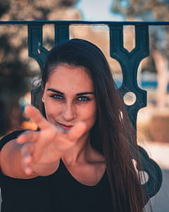 Woman Wearing Black Top While Smiling thumbnail