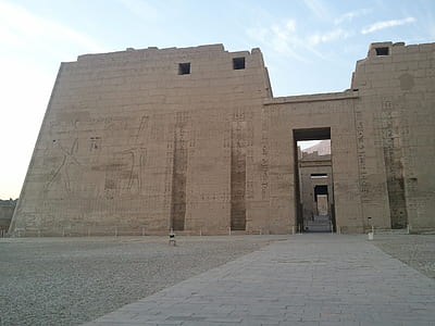 Egyptian ruins under cloudy sky thumbnail