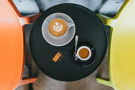 two coffee cups on table thumbnail