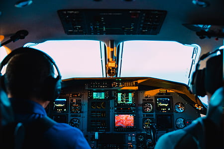 two pilot seating beside flight control panel during daytime thumbnail