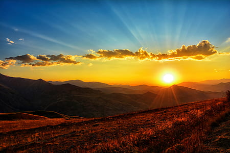 photo of brown mountain range during sunset thumbnail