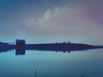 silhouette photo of bridge above body of water thumbnail