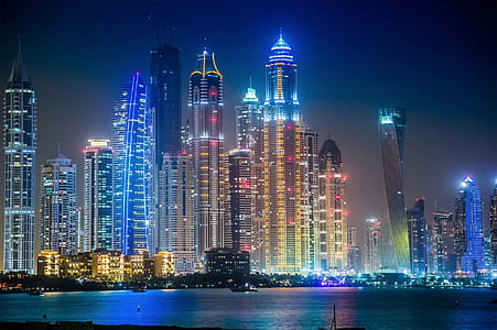 high rise building near body of water during nighttime thumbnail