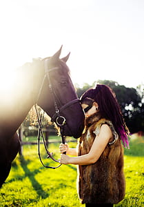 woman standing beside horse thumbnail