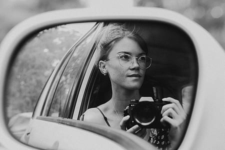 grayscale photography of woman holding camera thumbnail