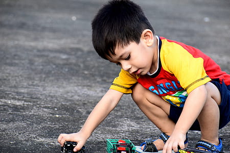 boy playing with toy cars thumbnail