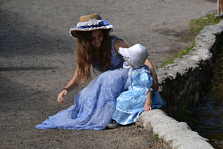 photograph of girl seating beside toddler thumbnail