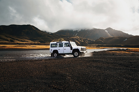 white SUV on body of water thumbnail