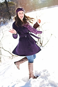 woman in purple coat on snow field thumbnail