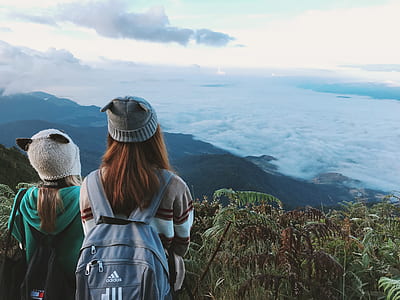 Two Woman Wearing White and Gray Crater Hat thumbnail