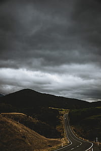 gray concrete road across mountains thumbnail