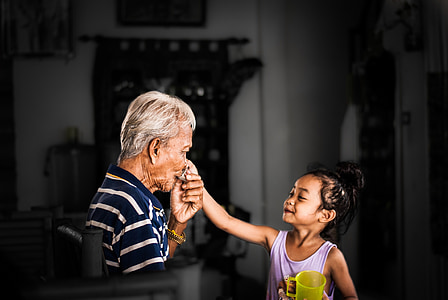 selective focus photography of man kissing girl's hand thumbnail