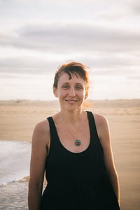 smiling woman in black tank top thumbnail