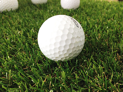 white golf ball on green grass field thumbnail