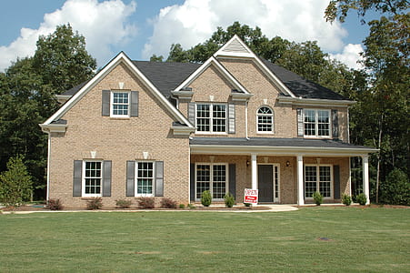brown and gray concrete house near trees thumbnail