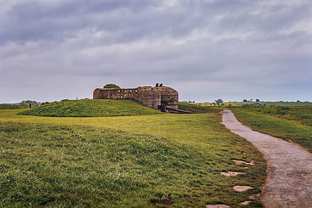 brown house near dirt road at daytime thumbnail