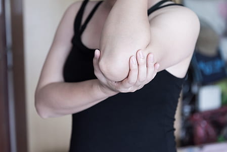 woman holding her left elbow thumbnail