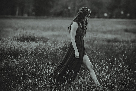A woman in a dress walks in a field thumbnail