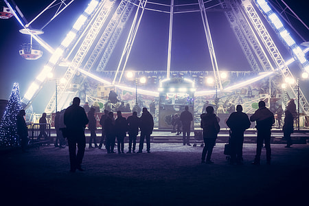 people standing near ferris wheel theme park ride during nighttime thumbnail