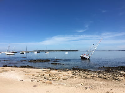 white sailboat on body of water thumbnail
