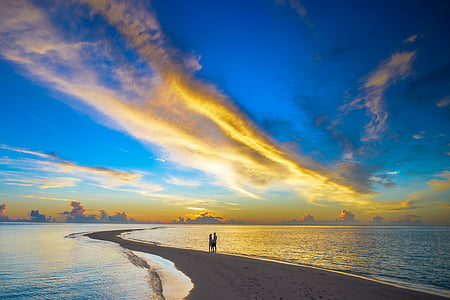two person standing on beach shore with a pathway leading on ocean thumbnail