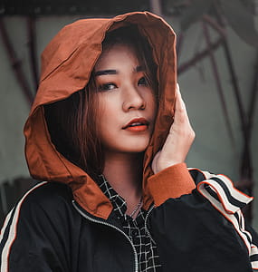 Woman Wearing Black, Brown, and White Hooded Jacket thumbnail