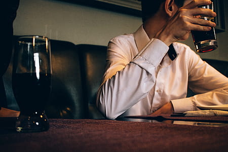 Photography of a Man Holding Drinking Glass thumbnail