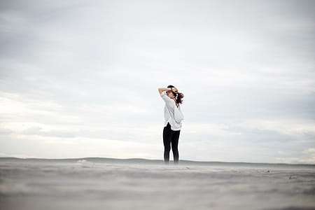Woman Standing Alone While Holding Her Hair thumbnail