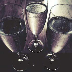 three clear wine glasses on brown wooden surface thumbnail