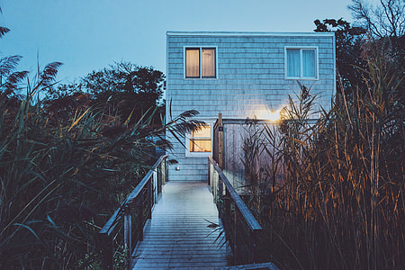 photography of gray concrete house in front of bridge thumbnail