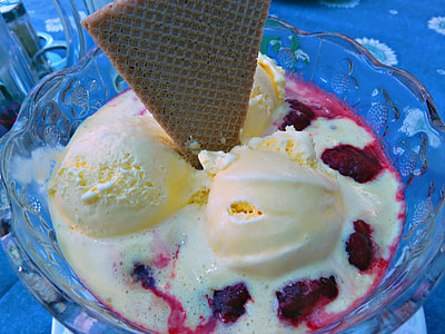 scoop of ice cream topped with wafer in round clear glass bowl thumbnail