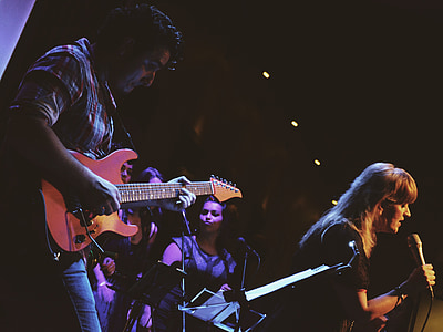 man playing guitar beside woman singing thumbnail