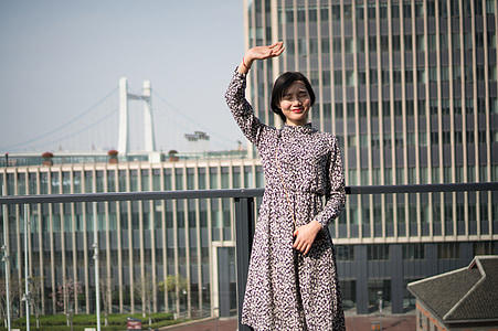 woman standing on gray bridge thumbnail